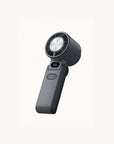 Portable handheld cooling fan on a neutral background, front view.