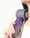 Woman using a portable handheld cooling fan near her neck, showing the cooling plate providing instant cooling relief.