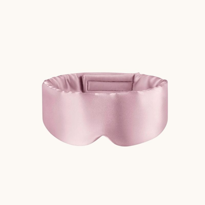 Pink silk eye mask on a white background