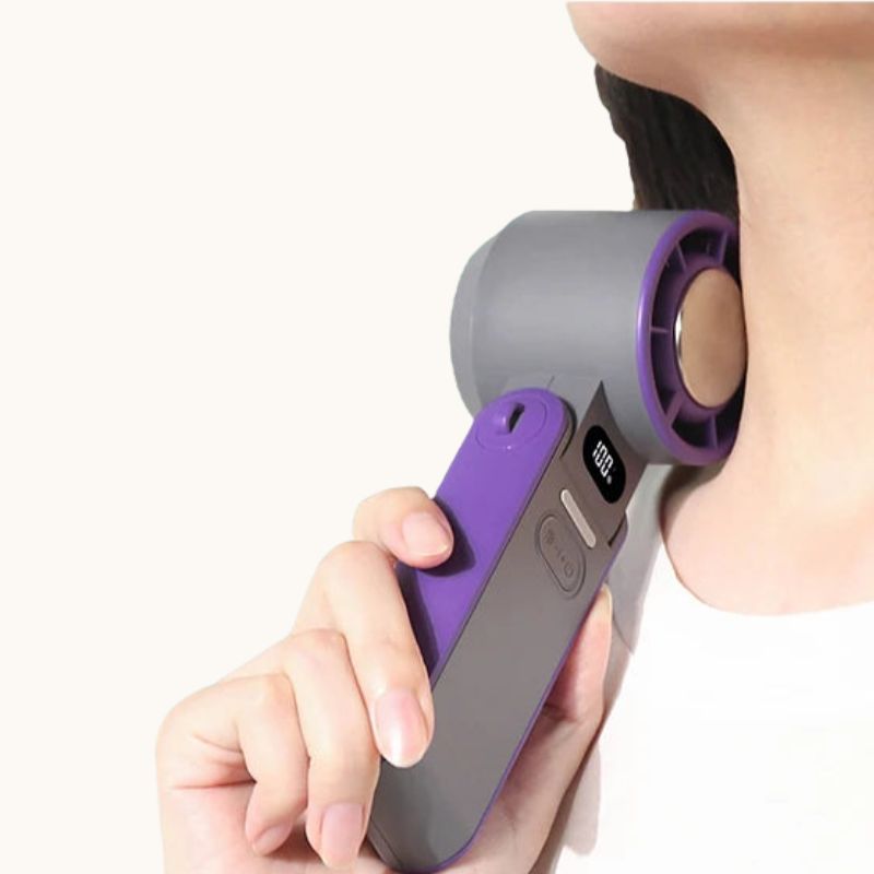 Woman using a portable handheld cooling fan near her neck, showing the cooling plate providing instant cooling relief.